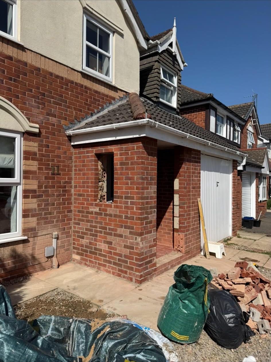 Brick porch being built at the front of a house